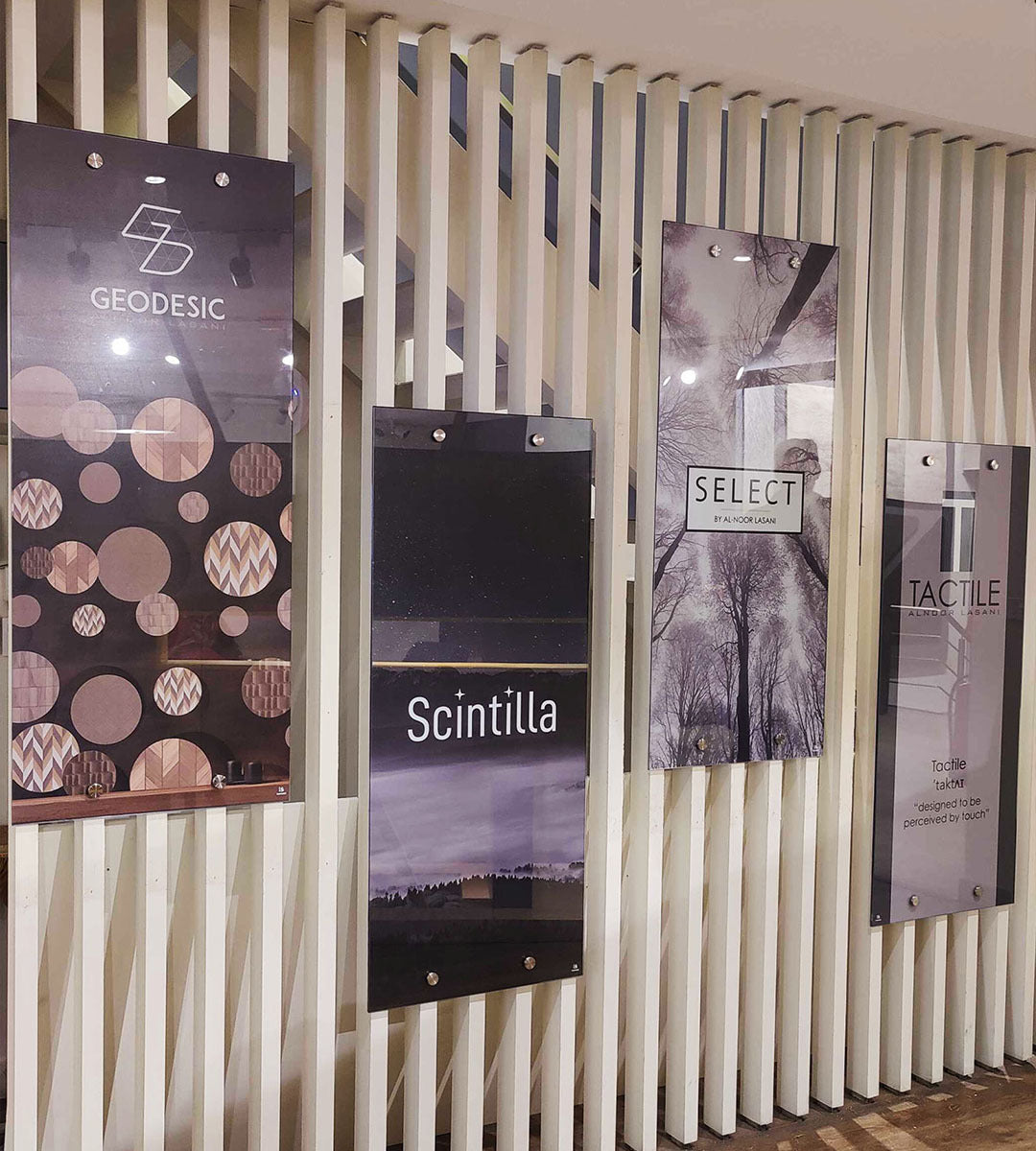 Modern indoor display of wall-mounted business signage with acrylic and graphic designs.