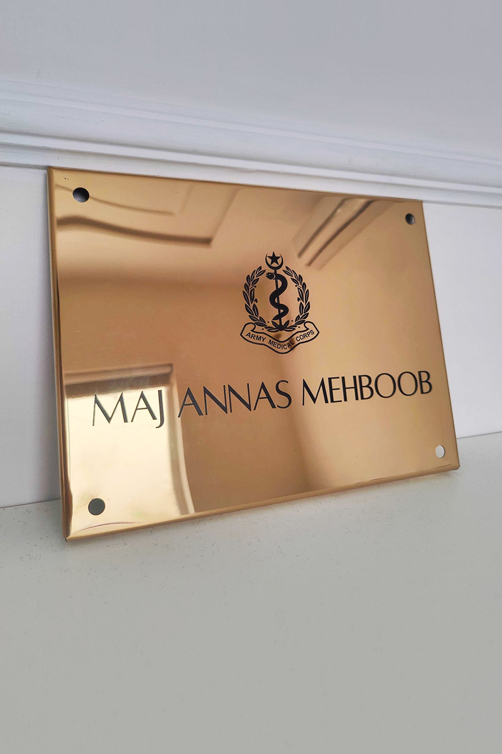 Custom gold metal nameplate with Army Medical Corps emblem for office or business use